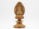 A statue of Dainichi Nyorai Buddha of the Shingon sect, made of camphor wood, surrounded by a halo of flying clouds, on an octagonal base.